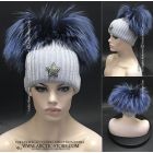 women beanie in light aurora color with two big blue fox fur pompoms